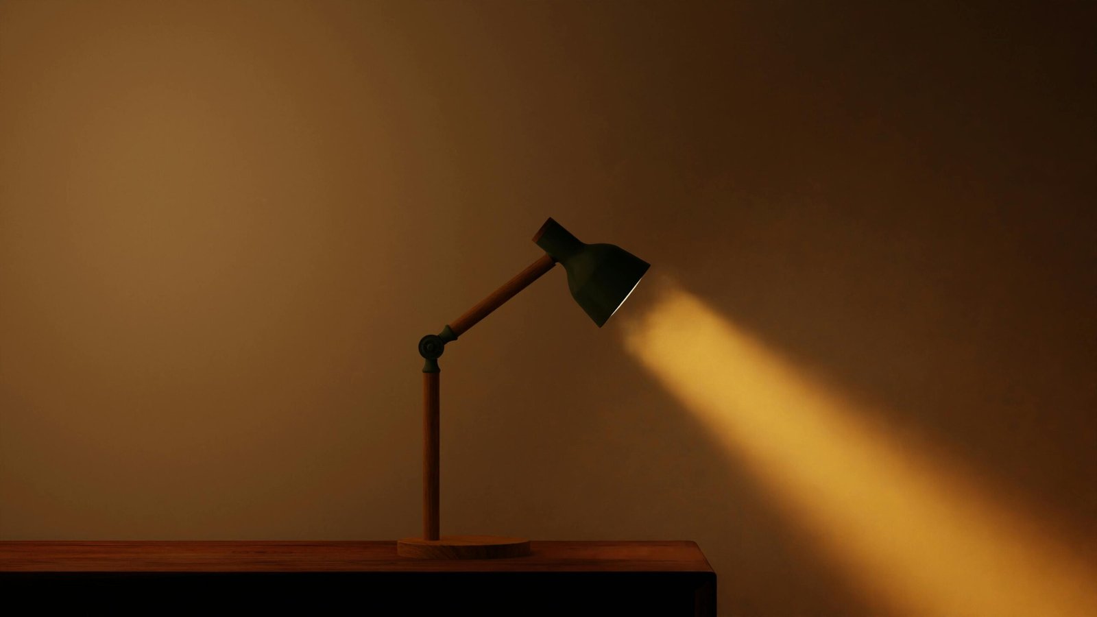 A minimalist desk lamp casting a warm beam of light on a wooden surface.